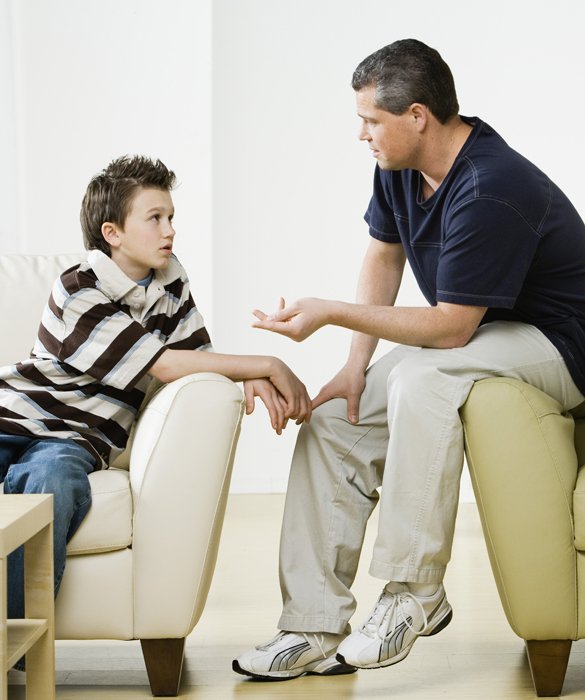 Preteen boy talking to father about serious stuff 